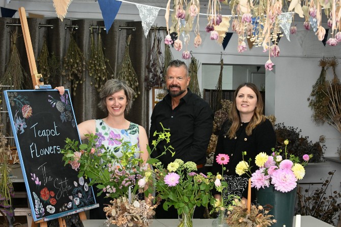 Owners of Teapot Flowers stood by some flowers